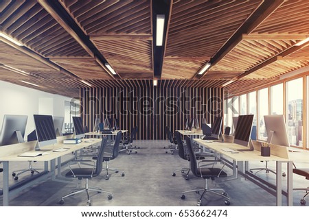 Front view of an open space office interior with wooden walls, panoramic windows and a row of tables standing along the wall. Blank computer monitors. 3d rendering mock up toned image