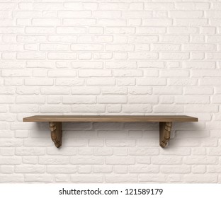 A front view of a regular cleared wooden shelf with wooden brackets on an white brick wall with copy space