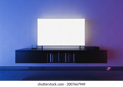 Front View Of A White Backlit Television Mockup In A Living Room With Blue And Red Lighting. 3d Render