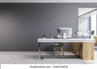 Front View Of A Wood And Gray Office Workplace With A Concrete Floor And A Computer Table. A Mock Up Wall. 3d Rendering