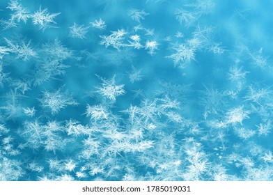 Frosty pattern on window in winter season. Abstract frosty pattern on glass. frosted glass texture. Blue foil freeze gradient texture background. The frozen water. Winter and Snow background.