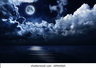 Full Moon In Night Sky Over Moonlit Water