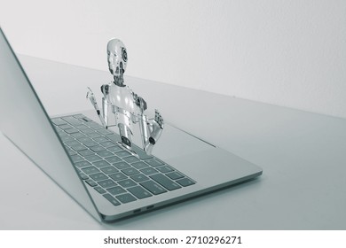 Futuristic 3D humanoid robot emerging from laptop screen, representing artificial intelligence, chatbot assistant, virtual reality, and future technology concept on white office desk.