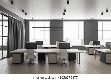 Futuristic Grey Coworking Office Interior With Equipment And Computers On Desktop,  Furniture And Daylight. 3D Rendering