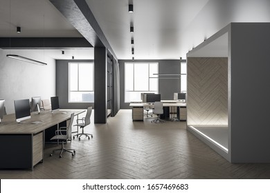 Futuristic Grey Coworking Office Interior With Equipment And Computers On Desktop, Other Pieces Of Furniture And Daylight. 3D Rendering