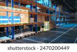 Futuristic warehouse. Innovation storage. Multi-tiered warehouse racks with goods. Storage is divided into virtual sectors. Futuristic warehouse without people. Logistics center in hangar. 3d image