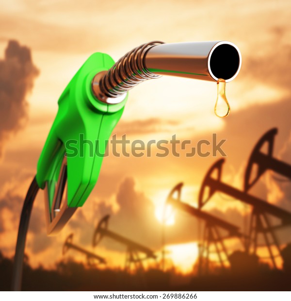 Gasoline drop down the pump with the\
sunset in the background. Depth of field at the\
drop.