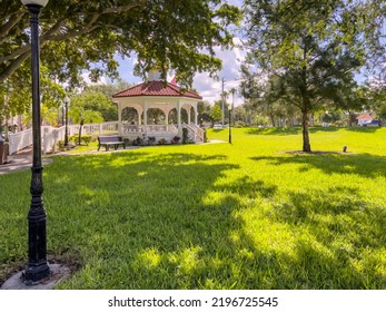 Gazebo And Lawn Of A Public Park, Often A Festival Venue, On A Sunny Day In Summer, Venice, Florida. Light Digital Oil-painting Effect, 3D Rendering.