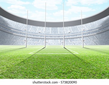 A Generic Seated Aussie Rules Stadium Showing Goal Posts On A Green Grass Pitch In The Day Time Under A Blue Cloudy Sky - 3D Render