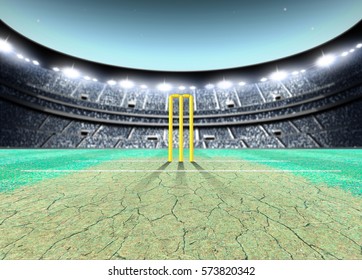 A generic seated cricket stadium with cracked pitch and yellow wickets on a green grass pitch at night under illuminated floodlights - 3D render
