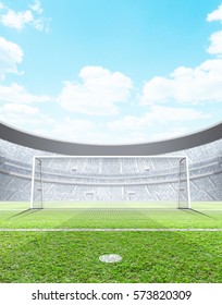 A Generic Seated Soccer Stadium Showing A Set Of Goals And Penalty Spot In The Day Time Under A Blue Cloudy Sky - 3D Render