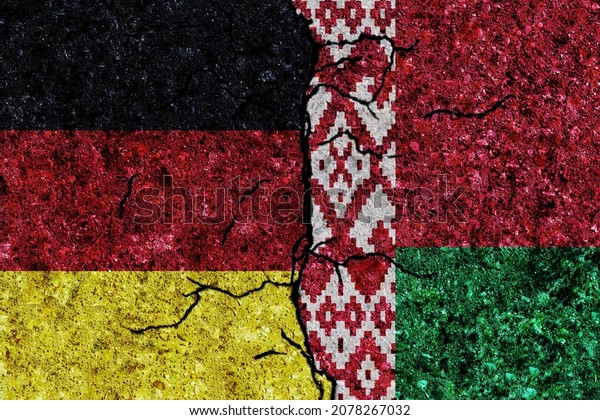 Germany and Belarus painted flags on a wall with\
grunge texture. Germany-Belarus conflict. Germany and Belarus flags\
together