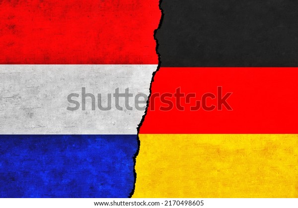 Germany and Netherlands painted flags on a wall\
with a crack.Netherlands and Germany relations. Germany and\
Netherlands flags\
together