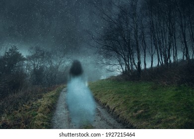 A ghostly transparent woman. Floating above a track on a the edge of a forest. On an atmospheric winters night. With a grunge, blurred vintage edit. - Powered by Shutterstock