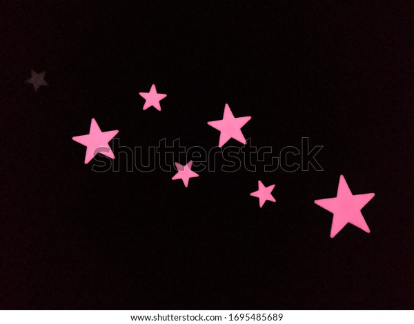 Glow in the dark\
stickers. Glowing stars on kids bedroom ceiling. Bright, shimmering\
neon stars. 