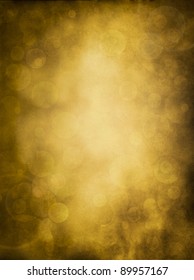 Glowing bokeh effects on a textured paper background.  Image has a pleasing grain pattern at 100%.