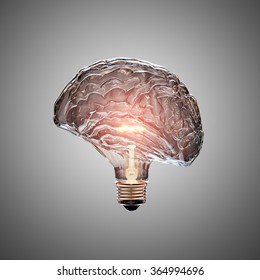 Glowing Light Bulb With The Glass Shaped As A Brain. This 3D Illustration Is Conceptual Of An Active, Creative, Thinking Mind Or Idea.