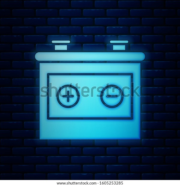 Glowing neon Car battery icon isolated on\
brick wall background. Accumulator battery energy power and\
electricity accumulator battery. \
