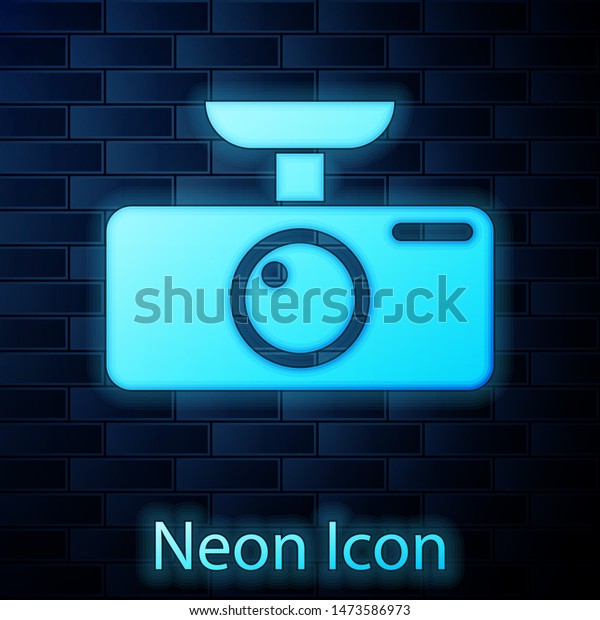 Glowing neon Car DVR icon isolated on\
brick wall background. Car digital video recorder\
icon