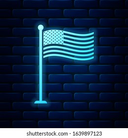 Glowing neon National flag of USA on flagpole icon isolated on brick wall background. American flag sign