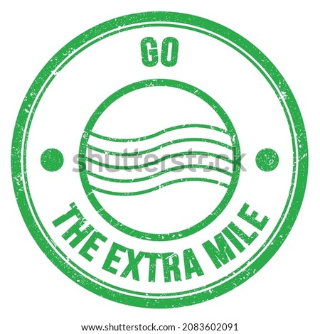 GO THE EXTRA MILE text written on green round postal stamp sign