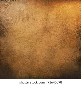 gold brown background paper with vintage grunge background texture with black scuffed edges and old faded antique design has copy space for ad brochure or announcement invitation, abstract background
