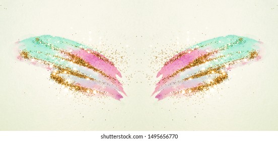 Golden glitter on abstract pink and blue watercolor wings in vintage nostalgic colors.