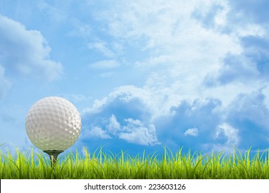 golf ball on green lawn  over a blue sky background. High resolution. 3D image 