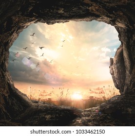 Good friday concept: Empty tomb stone and meadow sunrise background