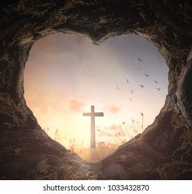 Good Friday concept: Heart shape of empty tomb stone with the cross over meadow sunrise background - Powered by Shutterstock