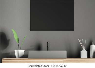 Gray angular bathroom sink standing on wooden countertop with rectangular mirror above it in gray wall room. 3d rendering