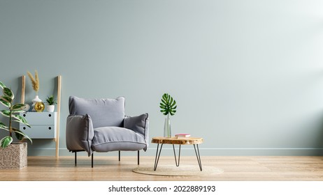 Gray armchair and a wooden table in living room interior with plant,dark blue wall.3d rendering