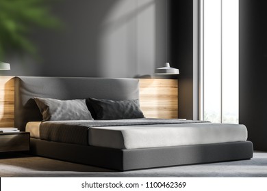 Gray bedroom interior with a concrete floor and a king size bed. A side view and a close up. 3d rendering mock up - Shutterstock ID 1100462369