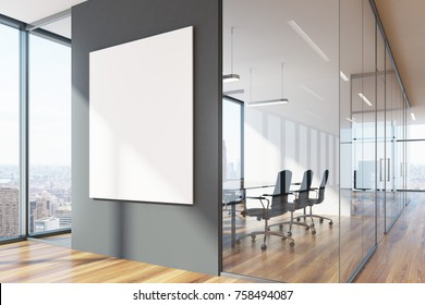 Gray and glass office waiting area with loft windows, a wooden floor, a vertical poster and a meeting room with black chairs. 3d rendering mock up