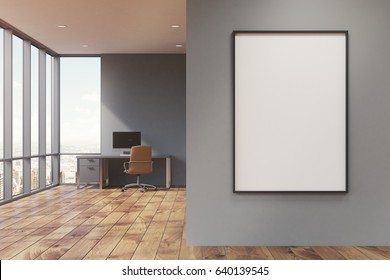 Gray Home Office Interior With Panoramic Windows, A Table With A Computer On It And A Framed Vertical Poster On A Foreground Wall. 3d Rendering, Mock Up