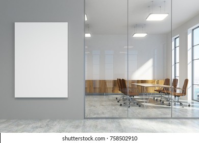 Gray Office Lobby With A Concrete Floor, Loft Windows And A Glass Wall. There Is A Large Vertical Poster And A Meeting Room. 3d Rendering Mock Up