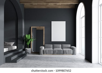 Gray Sofa Living Room Interior With Dark Gray Walls, Arched Windows, A Concrete Floor And A Frame Vertical Mirror Standing Next To A Sofa And A Vertical Mock Up Poster. 3d Rendering