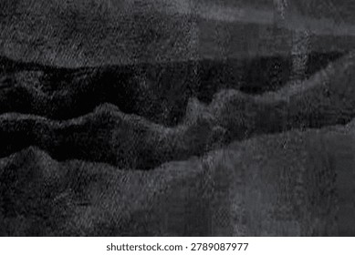 Grayscale abstract textured surface with undulating ridges and wave-like valleys creating depth and shadowed folds