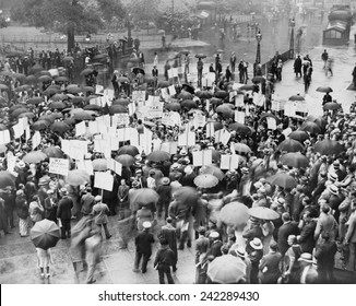 The Great Depression. A Crowd Of Depositors Protest In The Rain At The Bank Of United States After Its Failure. Signs Demand Bank Stockholders Be Taxed To Repay Small Depositors. New York City 1931.