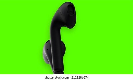 Green background. Motion. Black wireless headphones move in abstraction on a bright background.