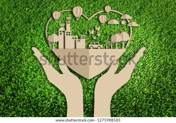 Green city. Paper art style of eco on green grass\
background.  Save the\
earth.