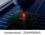 A green electronic chip is being cut by a laser. Concept of precision and technology