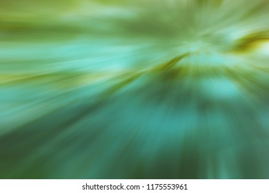Green orange converging light rays, abstract background design.