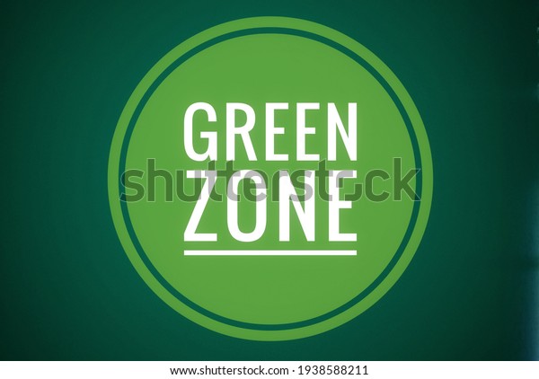 Green Zone - dark\
scary green colour with bright white fond in a double outline\
circle on dark green\
background