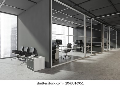 Grey Office Lobby With The Seating Next To An Empty Wall, Concrete Flooring, A Frame Glass Partition And Places For Work. Corner View. A Concept Of Modern Business Centre Design. 3d Rendering