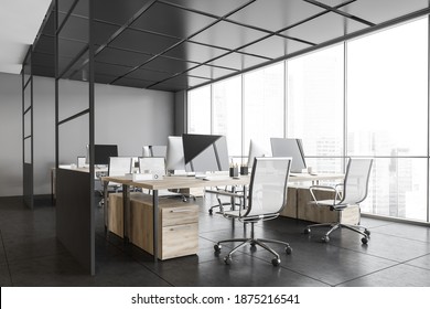 Grey Office Room With Armchairs And Computers On The Tables Near Windows, Side View. Dark Office Room With Modern Wooden Minimalist Furniture On Tiled Floor, 3D Rendering No People