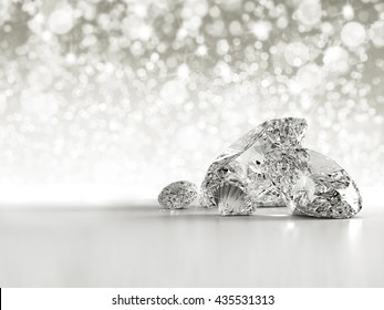 Group of diamonds placed on white background on the right with bokeh and light reflection, 3D illustration.