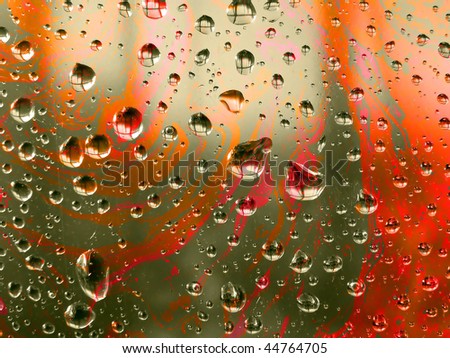 Drops on the window pane with reflection of the building opposite