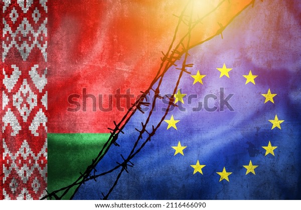 Grunge flags of Belarus and European Union divided\
by barb wire with sun haze illustration, concept of tense relations\
in migrant border\
crisis