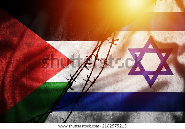 Grunge flags of Palestine and Israel divided by\
barb wire sun haze illustration, concept of tense relations between\
Palestine and\
Israel